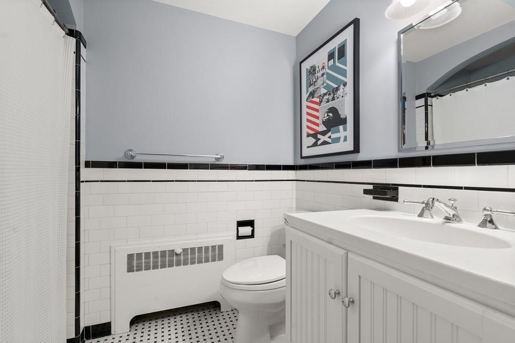 29 Pembroke Road Weston, MA 02493 - Photo 29 of 34 a bathroom with a toilet a sink and a window