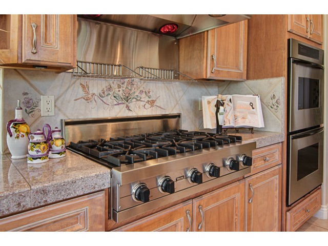 14065 Arnerich Road Los Gatos, CA 95032 - Photo 9 of 25 a kitchen with stainless steel appliances granite countertop a stove and a refrigerator