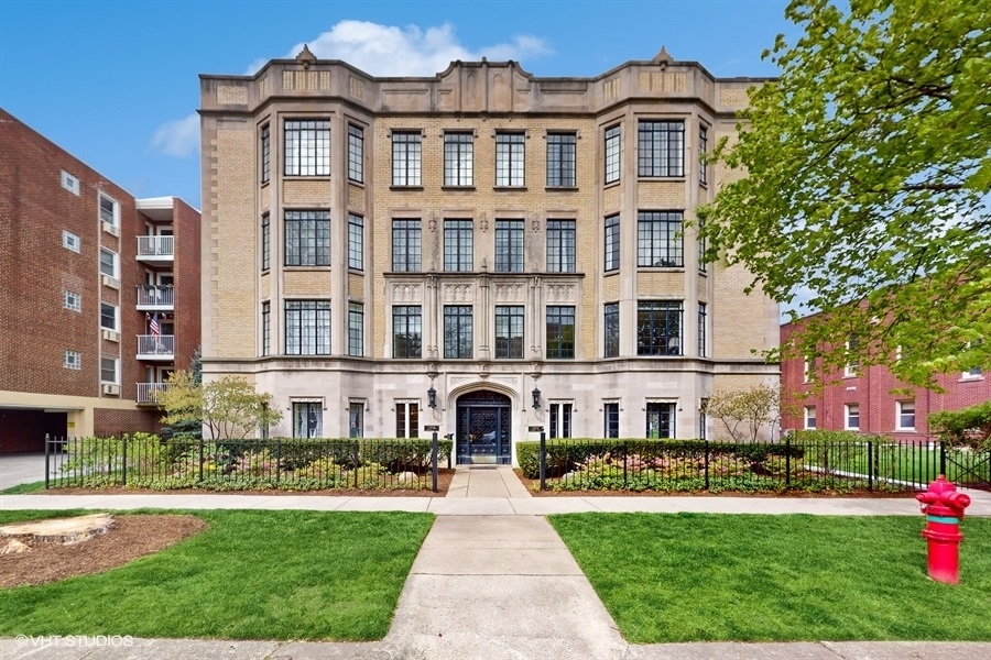 1316 Maple Avenue, Unit F1 Evanston, IL 60201 - Photo 1 of 13 a front view of a residential apartment building with a yard