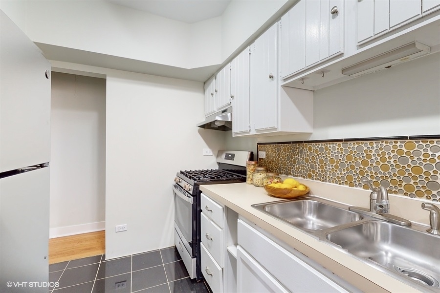 1316 Maple Avenue, Unit F1 Evanston, IL 60201 - Photo 5 of 13 a kitchen with a sink a stove and cabinets