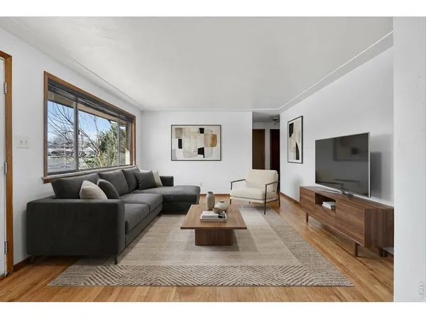 a living room with furniture window and a flat screen tv