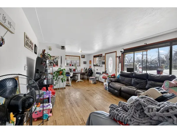 a living room with furniture and a floor to ceiling window