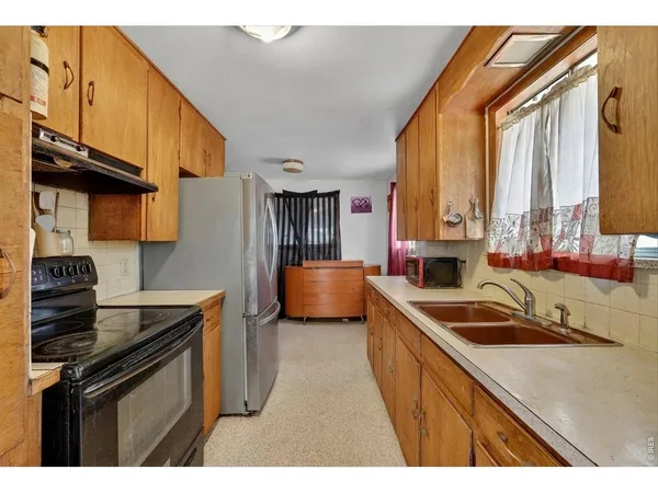 a kitchen that has a sink and a stove