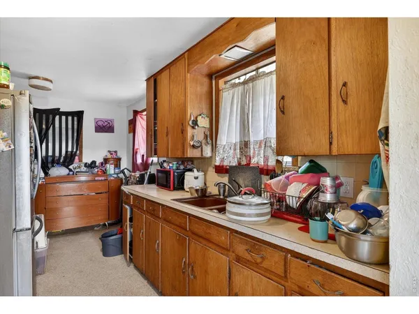a kitchen with stainless steel appliances a sink a stove and a refrigerator