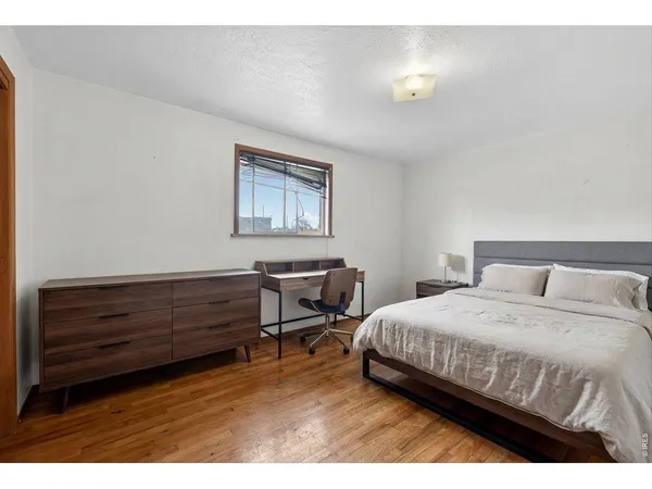 a bedroom with a bed and a table