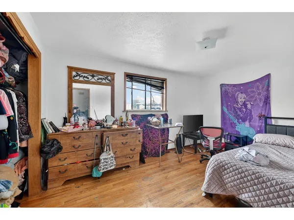 a bedroom with furniture and a window