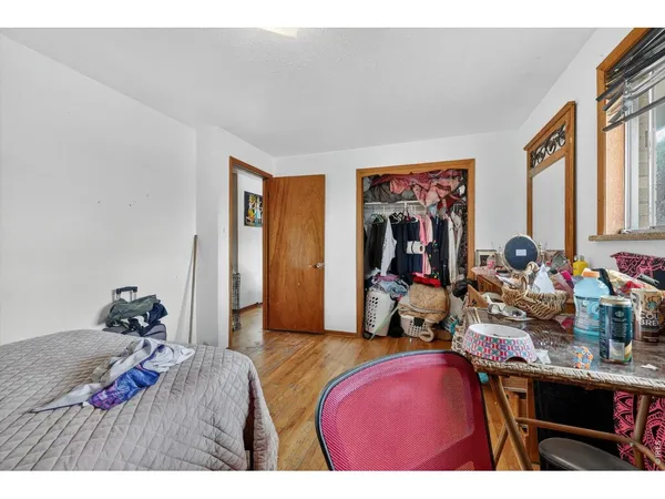 a bed room with a bed next to a window