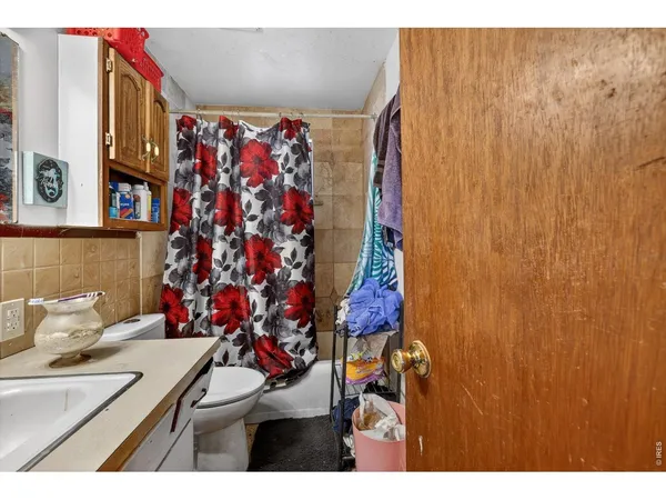 a view of a bathroom with a sink and a shower curtain