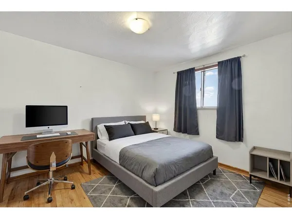 a bedroom with a bed and a desk