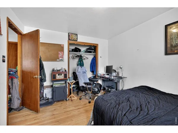 a bed room with a bed and a desk