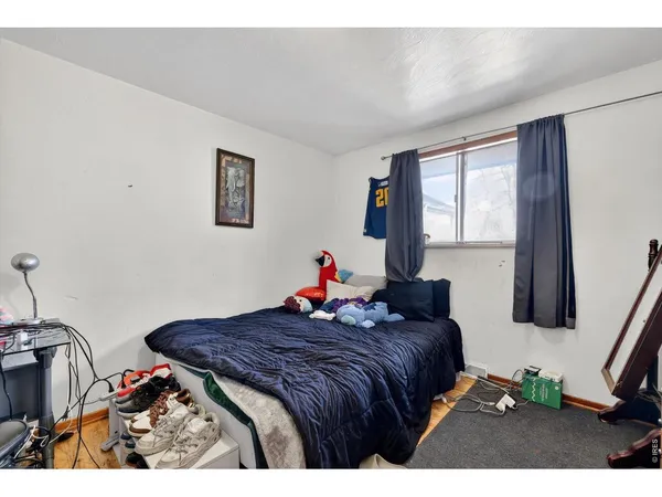 a bed room with a bed and a painting