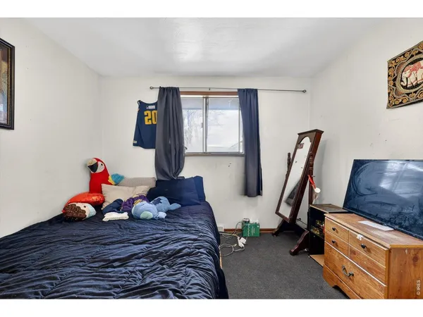 a bed room with furniture and a wooden floor