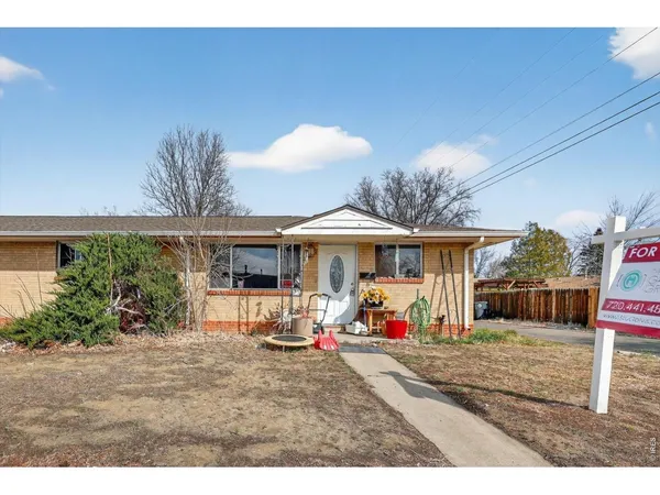 a view of a backyard with a table and chairs under an umbrella