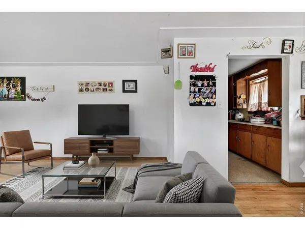 a bedroom with furniture and a flat screen tv