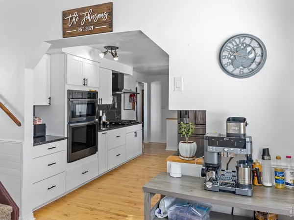 a kitchen with stainless steel appliances granite countertop a refrigerator and stove