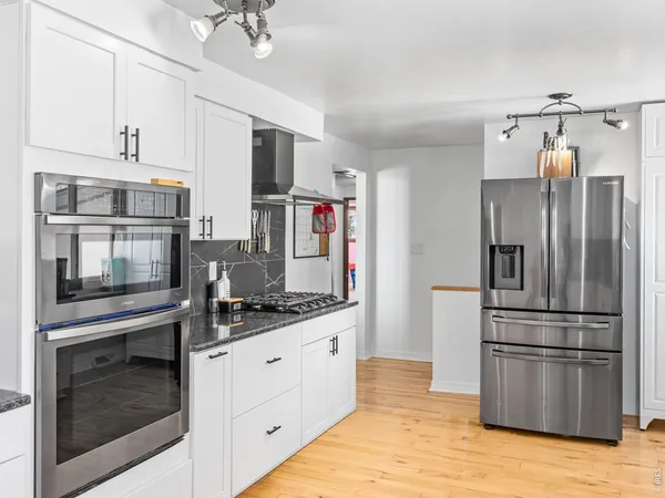 a kitchen with stainless steel appliances a refrigerator sink and microwave