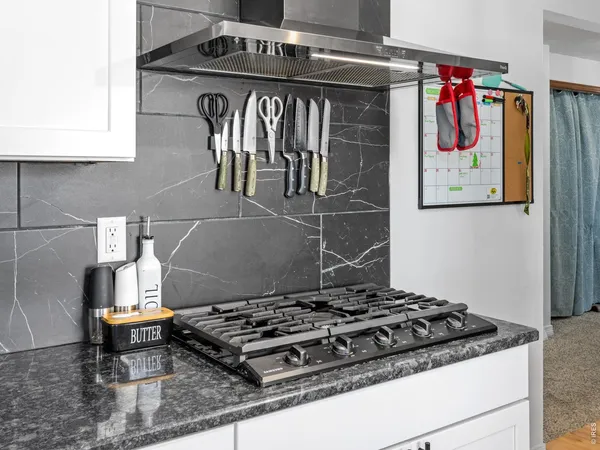 a stove top oven sitting inside of a kitchen