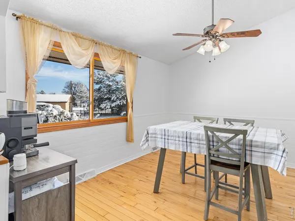 a view of a dining room with furniture and a window