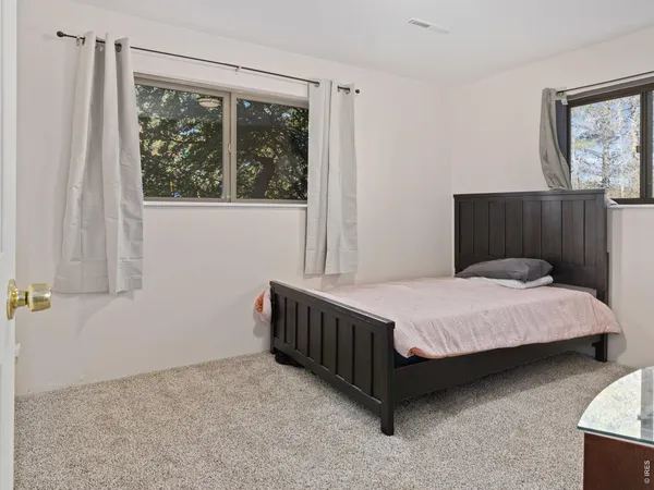 a bathroom with a granite countertop sink toilet and mirror