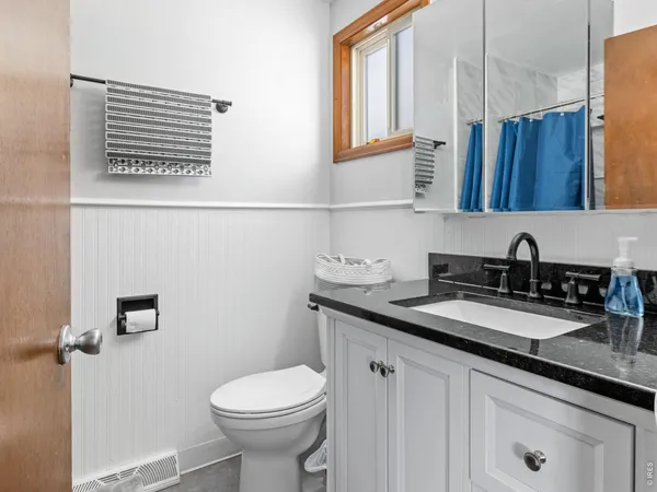 a living room with furniture and a bed