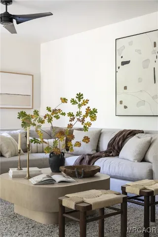 a living room with furniture and a floor to ceiling window