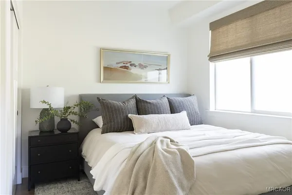 a en suite bathroom with a granite countertop sink and a mirror