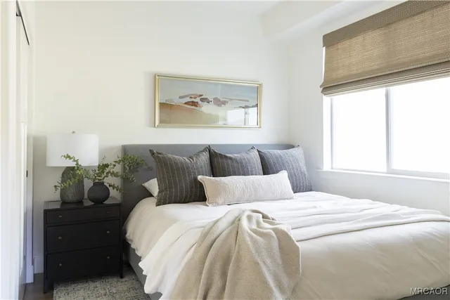 a en suite bathroom with a granite countertop sink and a mirror