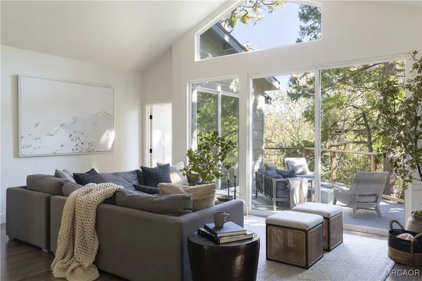 a kitchen with stainless steel appliances a sink a white table and chairs
