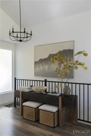 a large white bed in a bedroom next to a window