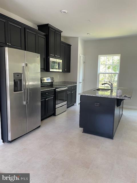 1813 Wind Gate Road Baltimore, MD 21227 - Photo 13 of 44 a kitchen with stainless steel appliances a refrigerator and a stove