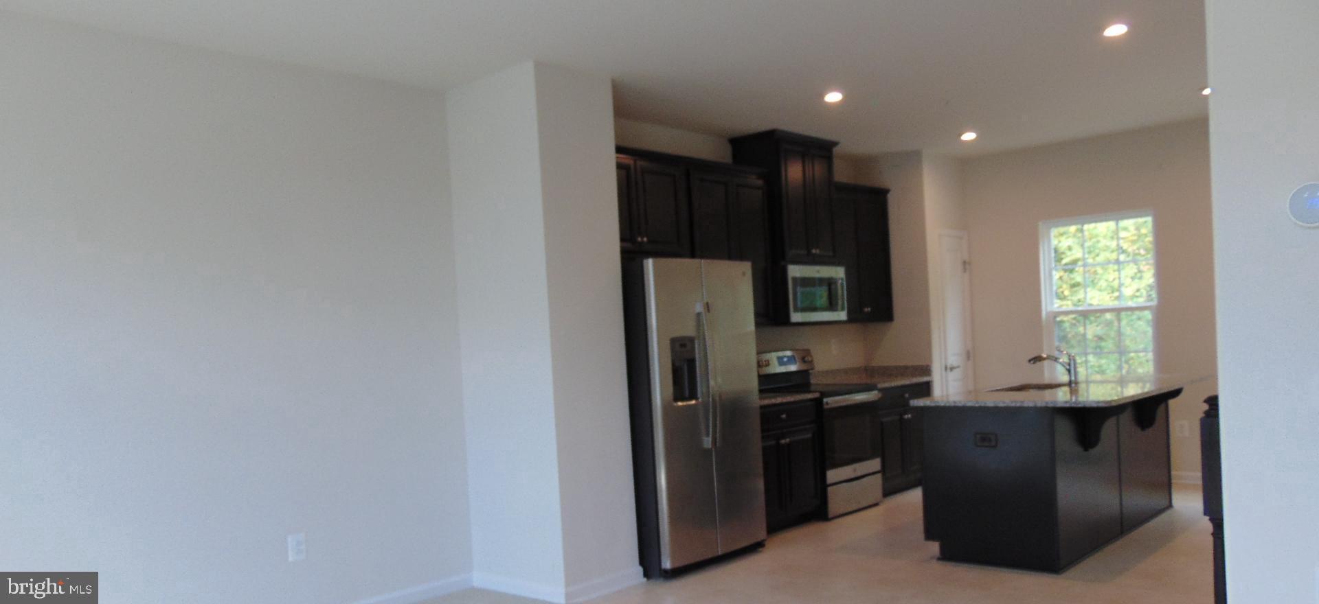 1813 Wind Gate Road Baltimore, MD 21227 - Photo 14 of 44 a kitchen with a refrigerator and a stove