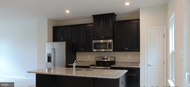 a kitchen with a sink a refrigerator and window