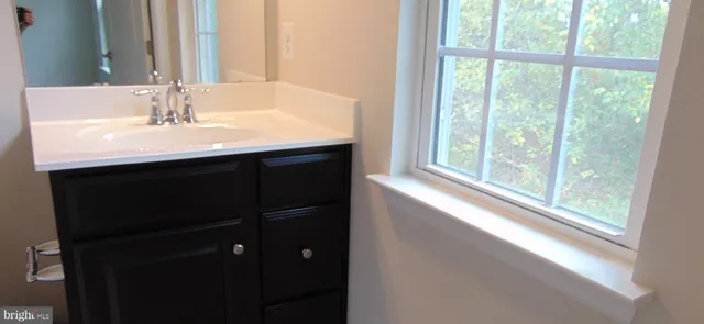 a white toilet sitting next to a shower