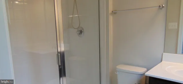 a bathroom with a glass shower door