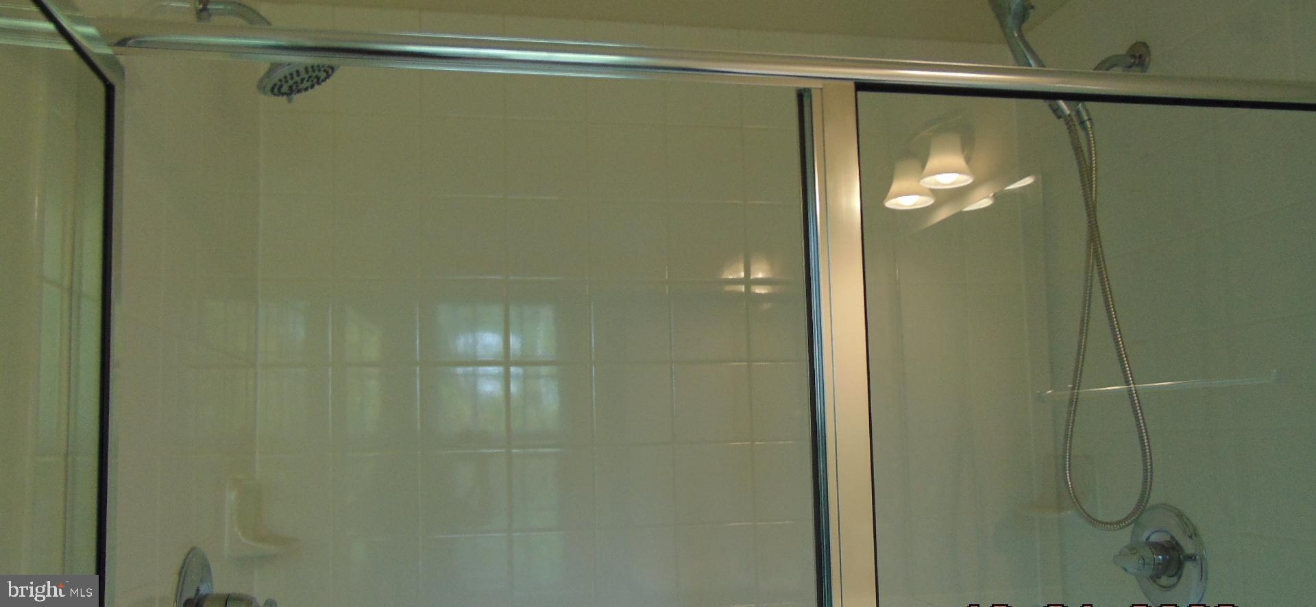 1813 Wind Gate Road Baltimore, MD 21227 - Photo 32 of 44 a bathroom with a glass shower door