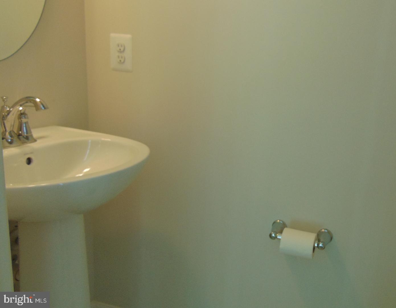 1813 Wind Gate Road Baltimore, MD 21227 - Photo 34 of 40 a bathroom with a sink and mirror