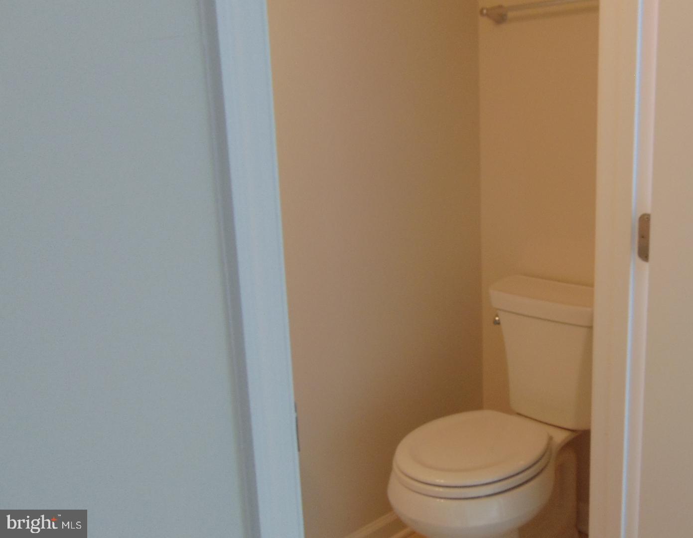 1813 Wind Gate Road Baltimore, MD 21227 - Photo 35 of 44 a white toilet sitting next to a white wall