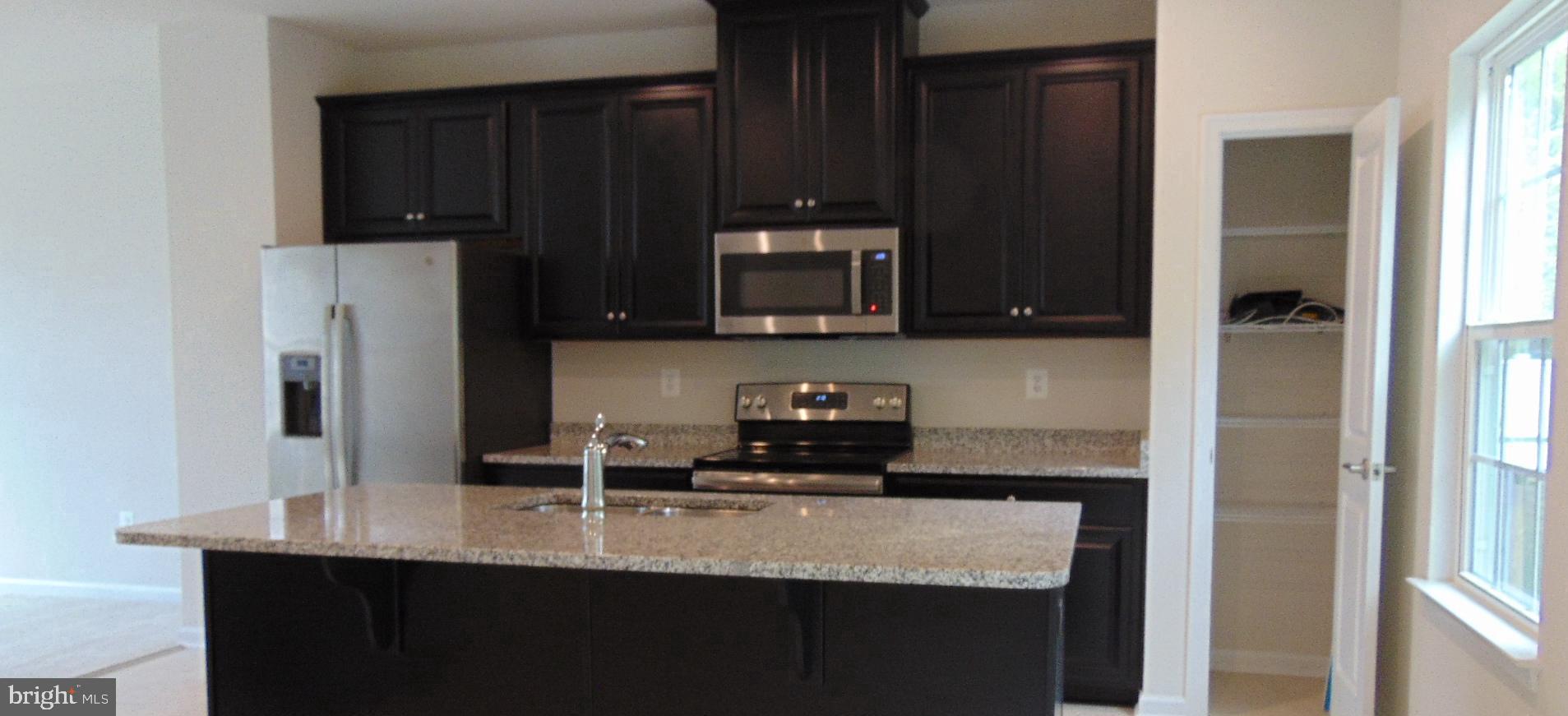 1813 Wind Gate Road Baltimore, MD 21227 - Photo 9 of 40 a kitchen with a sink and cabinets