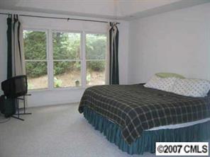 606 Keowee Lane Fort Mill, SC 29708 - Photo 7 of 8 a bedroom with a bed and a large window