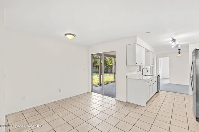 an empty room with windows and fireplace