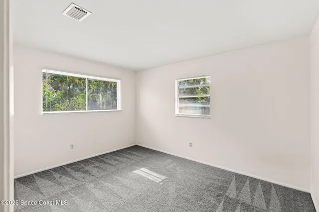 a view of empty room with sliding glass door