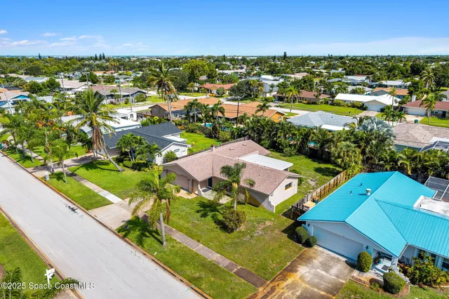 an aerial view of residential houses with outdoor space and street view