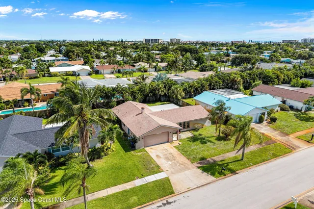 an aerial view of a house with a yard