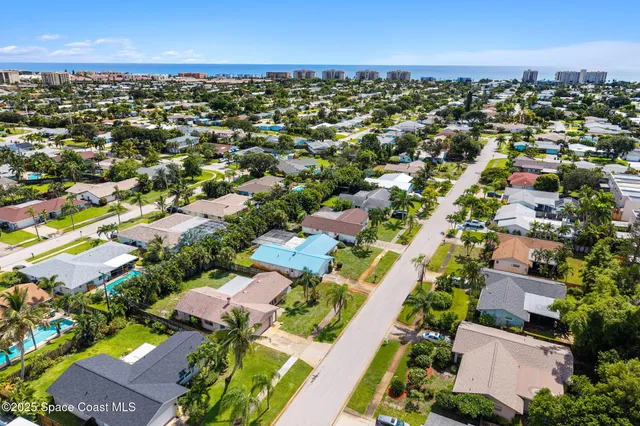 an aerial view of residential houses with outdoor space