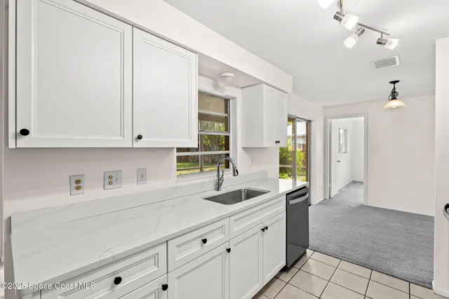 a kitchen with sink cabinets and window