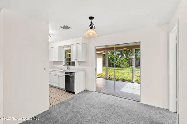 a open kitchen with a sink and a stove top oven
