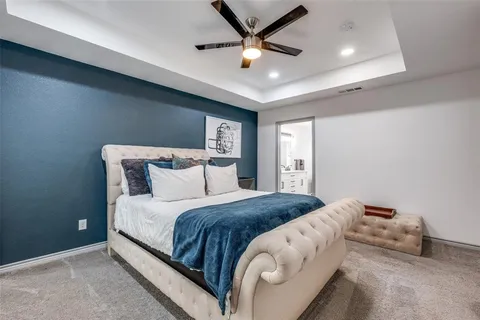 a bedroom with a bed and a ceiling fan