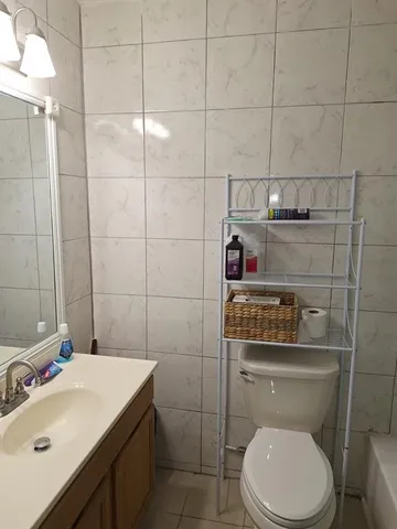 a bathroom with a toilet a sink and vanity