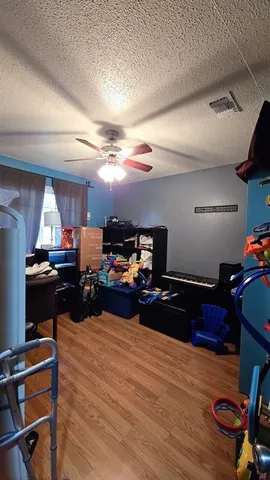 a bedroom with furniture and a wooden floor