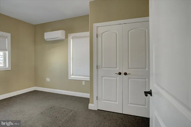 an empty room with closet area